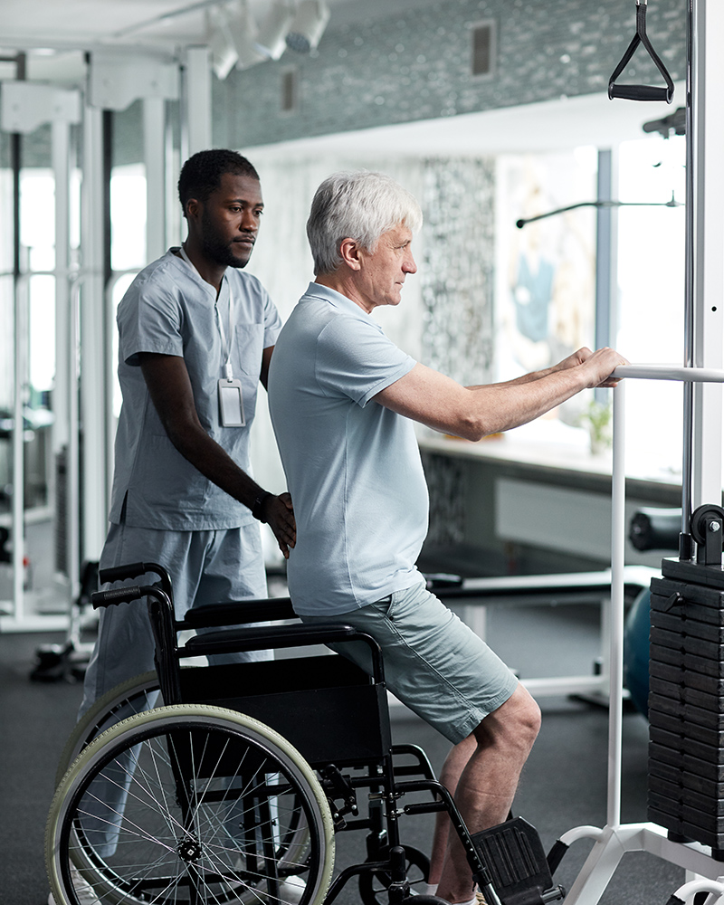 Senior Man doing Rehabilitation Exercises in Gym