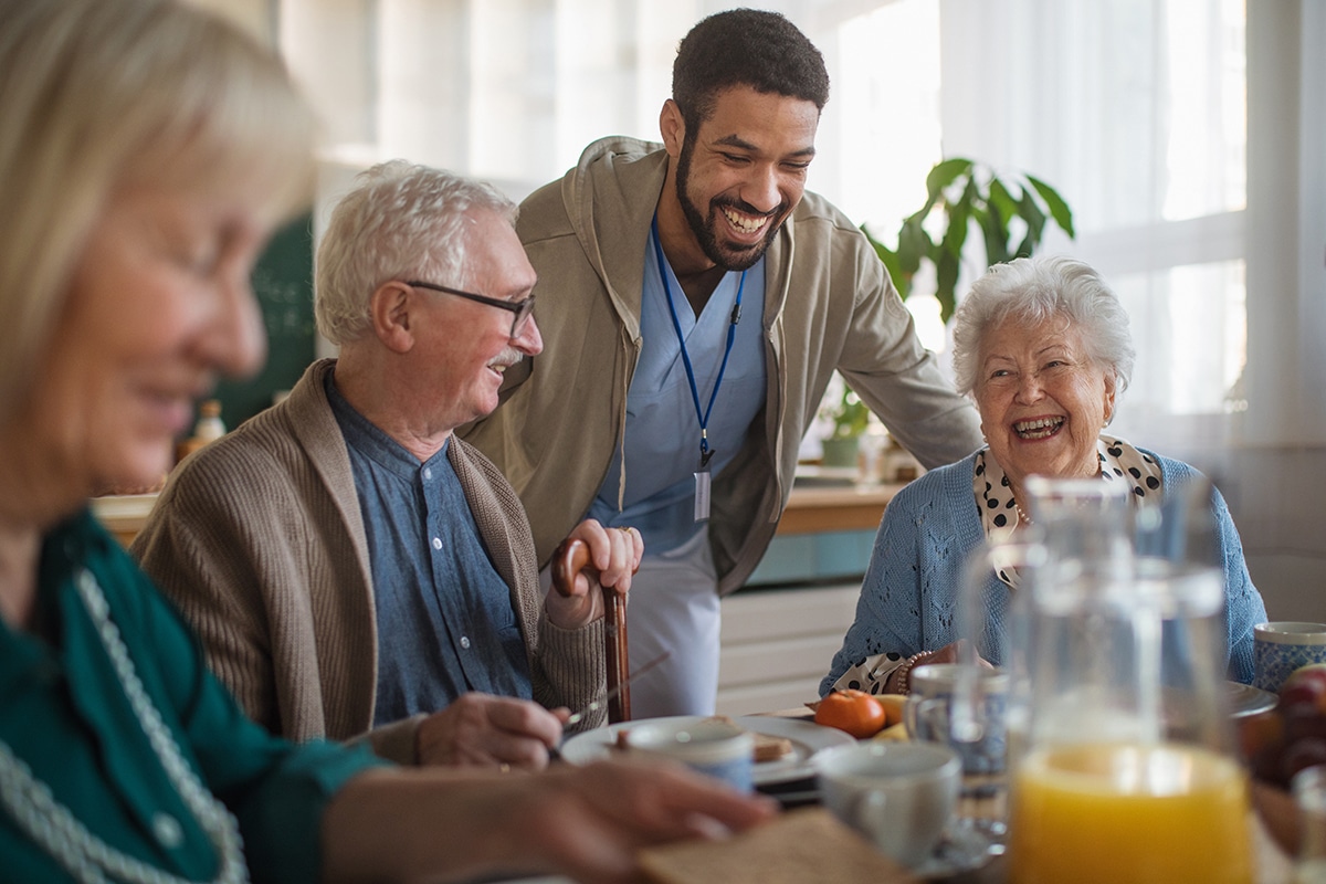 PACS-300x200-activity2 A group of cheerful seniors enjoying breakfast in nursing home care center.