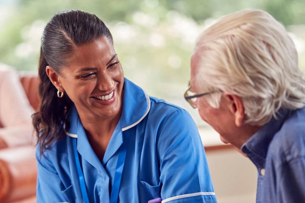 consultation Caregiver reviewing information on a tablet with an older man